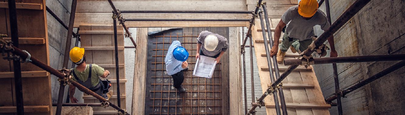 View of a construction site wit two workers talking.